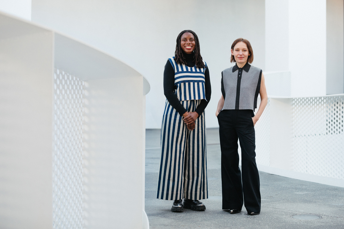 Essence Harden and Paulina Pobocha stand in a walkway with white railing.