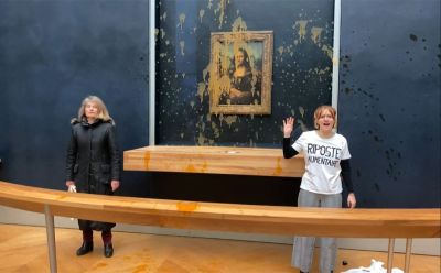 Two environmental activists from the collective Riposte Alimentaire in front of Leonardo da Vinci's Mona Lisa after throwing soup at the artwork at the Louvre, Paris, 2024.