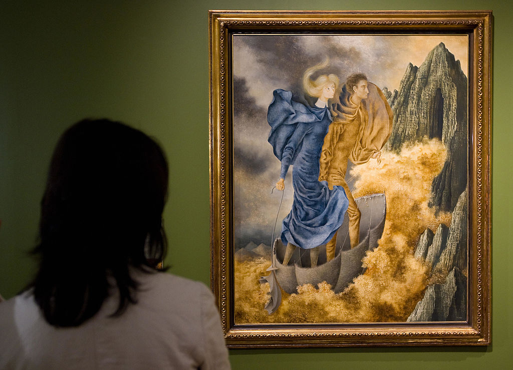 A visitor watches a painting by Spanish painter Remedios Varo on display at the Museum of Contemporary Art in Mexico City, on May 20, 2008.  AFP PHOTO/Ronaldo SCHEMIDT (Photo credit should read Ronaldo Schemidt/AFP via Getty Images)