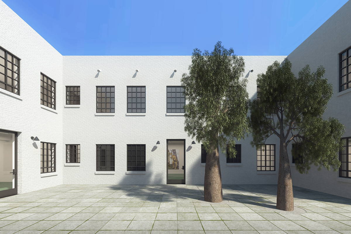 View of a courtyard of a two-story building with two trees on the right.